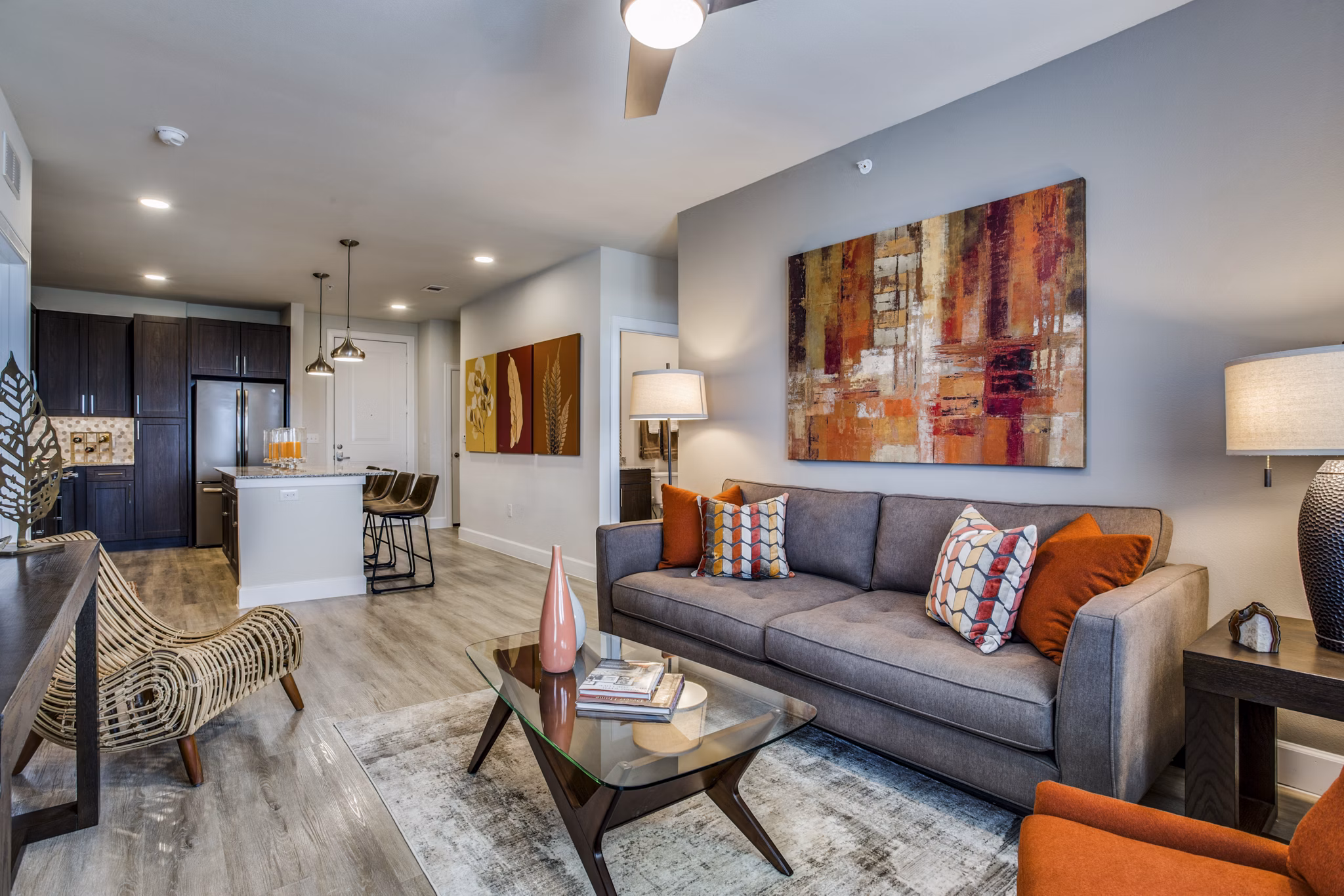 Spacious living room with modern furnishings at Quest Apartments