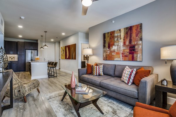 Spacious living room with modern furnishings at Quest Apartments