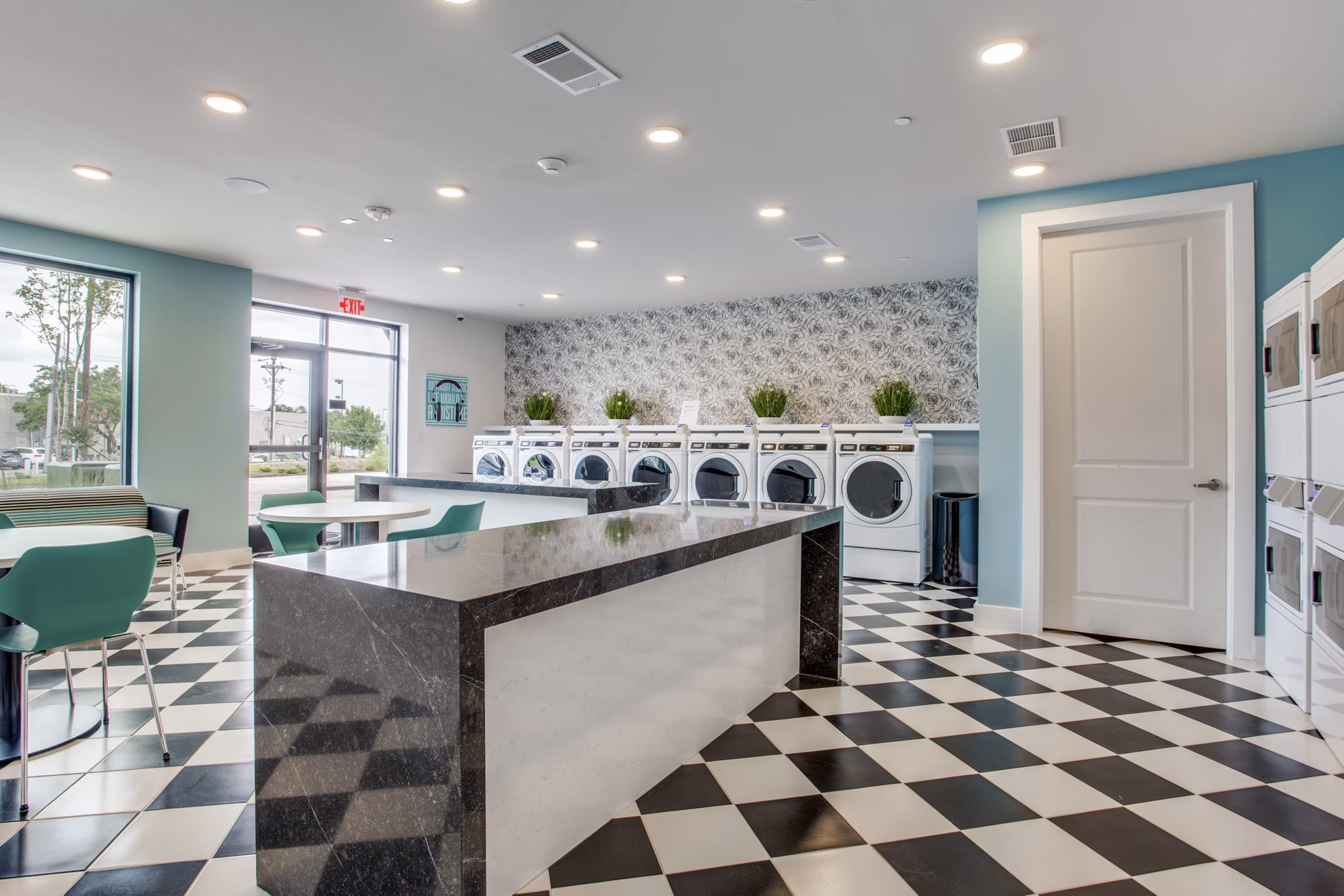 Modern laundry facility with state-of-the-art machines at Quest Apartments for resident convenience