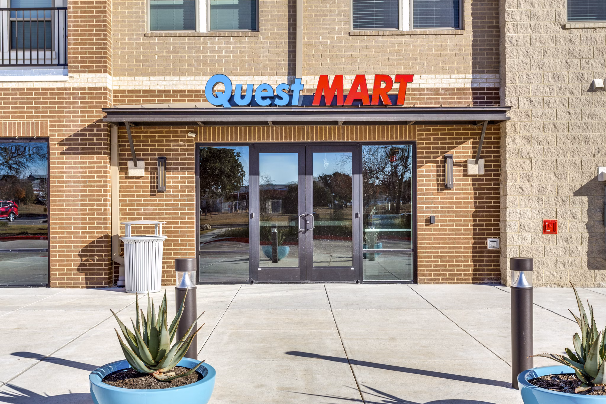 Quest Apartments: Serene neighborhood with tree-lined streets and modern architecture, located in a desirable area for luxury living