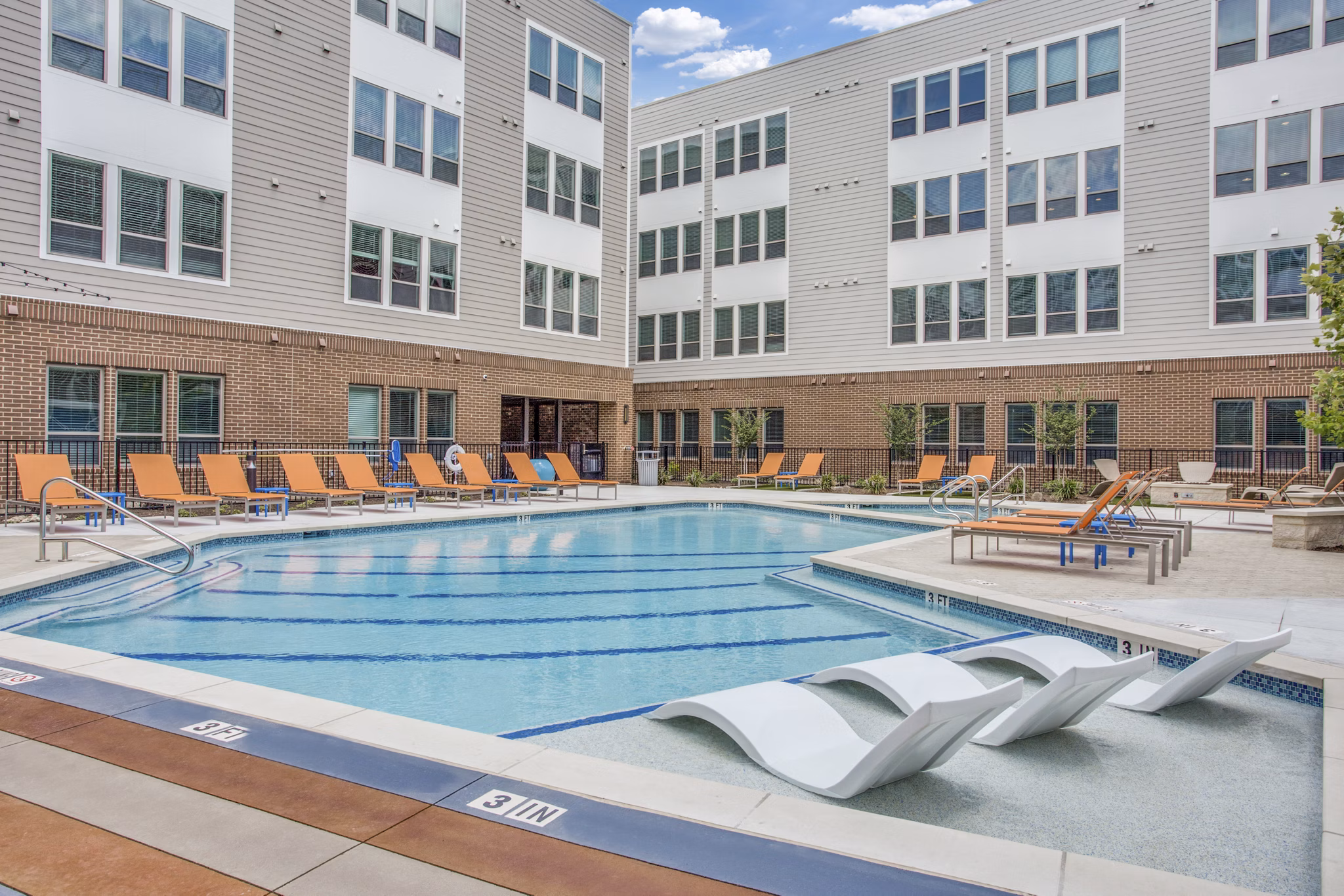 Luxurious pool surrounded by scenic views at Quest Apartments