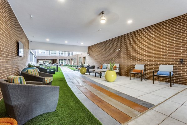 Chic outdoor patio with modern seating at Quest Apartments, perfect for relaxation and social gatherings in luxury living