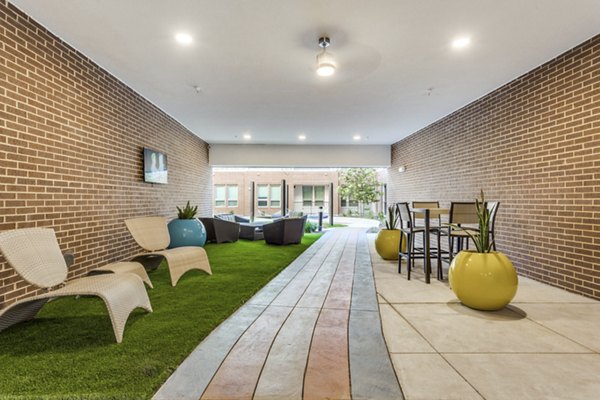 Patio with stylish outdoor seating at Quest Apartments, offering a relaxing space for residents to unwind and enjoy luxury living