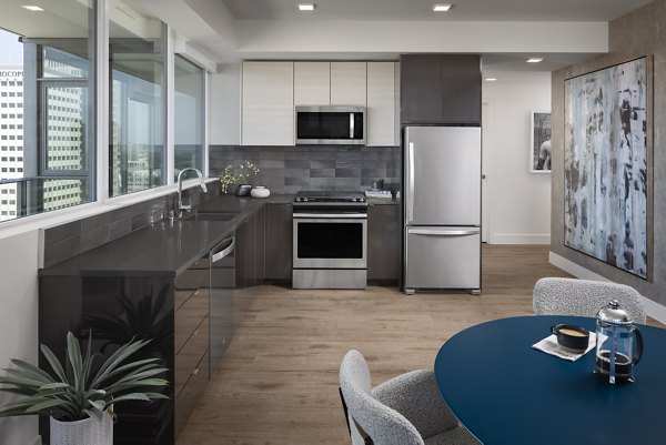 Modern kitchen with sleek countertops and stainless steel appliances in Diega Apartments, luxury living in the heart of the city