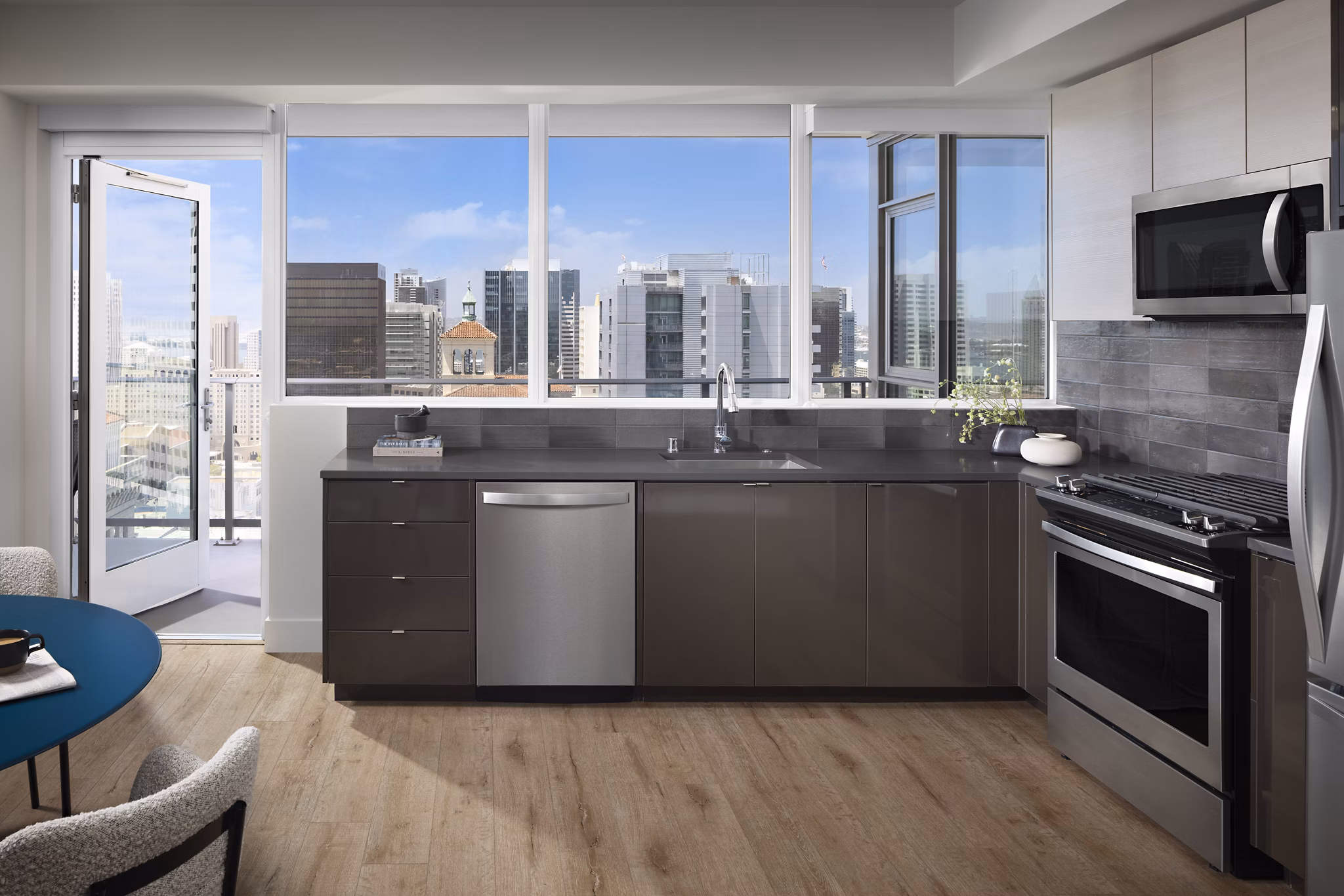 Modern kitchen with sleek appliances and marble countertops in Diega Apartments
