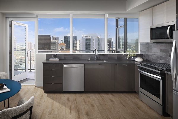 Modern kitchen with sleek appliances and marble countertops in Diega Apartments