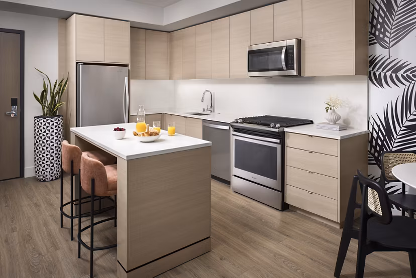 Modern kitchen featuring sleek countertops and stainless steel appliances in Diega Apartments