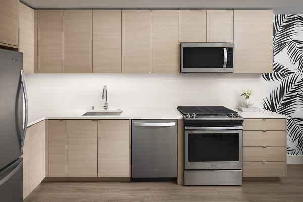 Modern kitchen featuring sleek cabinetry and stainless steel appliances at Diega Apartments, Greystar luxury property in downtown San Diego