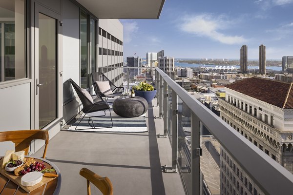 Patio with sleek furniture and city views at Diega Apartments, a luxury community
