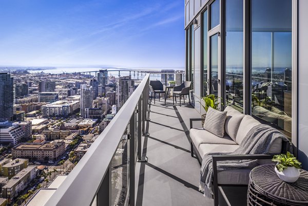 Private patio with modern seating and skyline views at Diega Apartments, luxurious living in a prime city location