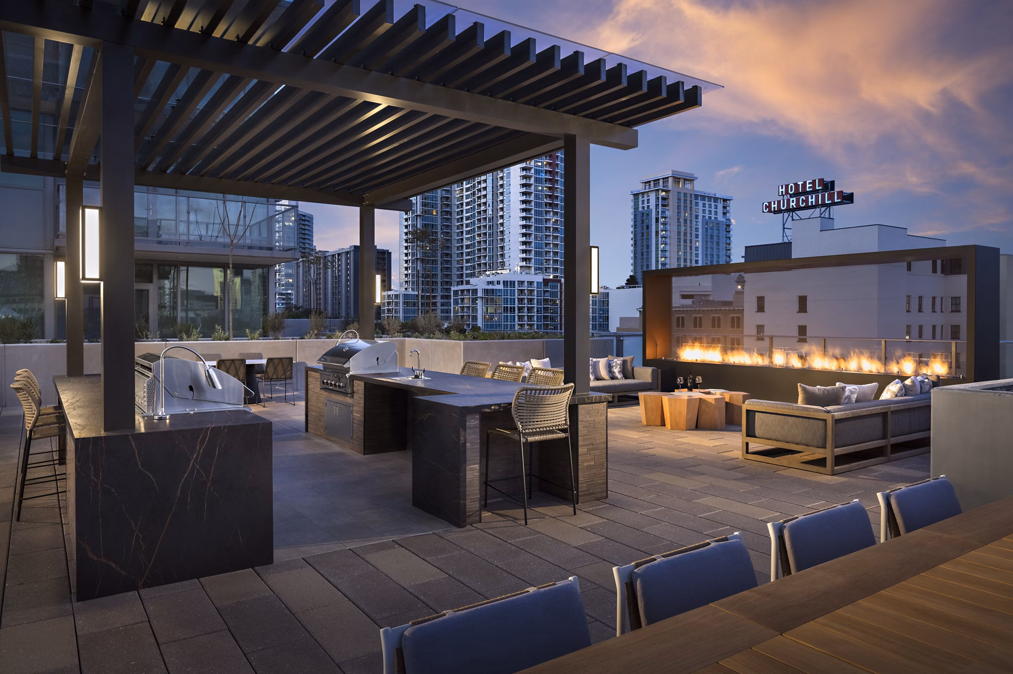Grill area with modern seating at Diega Apartments, luxury property in downtown San Diego Ideal for outdoor dining and entertainment