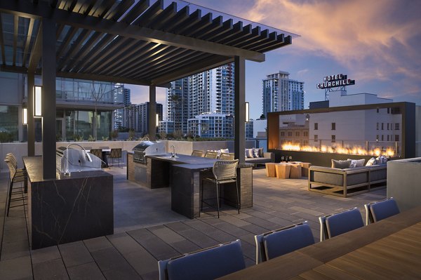 Grill area with modern seating at Diega Apartments, luxury property in downtown San Diego Ideal for outdoor dining and entertainment