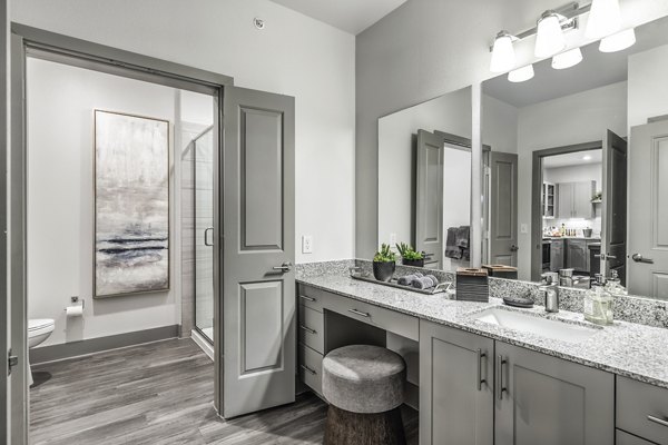 Modern bathroom featuring sleek fixtures and marble countertops at Arista Riverstone Apartments, luxury living spaces by Greystar
