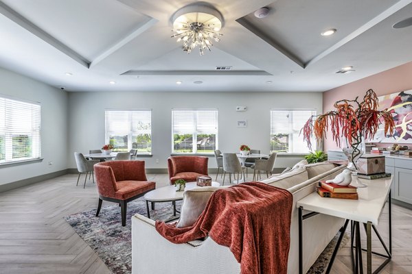 Clubhouse with modern design and cozy seating at Arista Riverstone Apartments