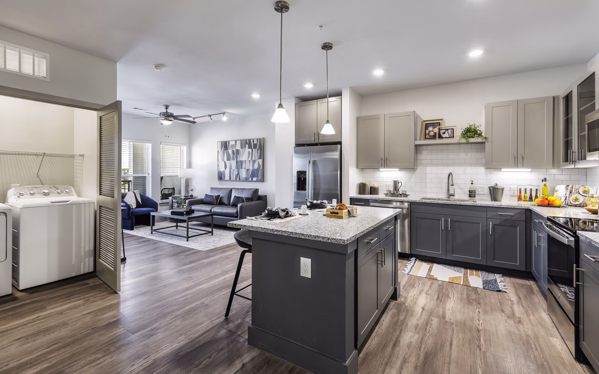 Elegant kitchen with stainless steel appliances in Arista Riverstone Apartments