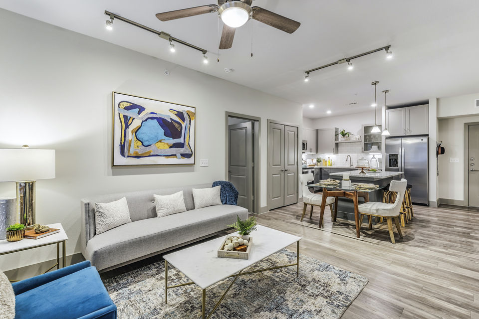 Spacious living room with modern decor in Arista Riverstone Apartments