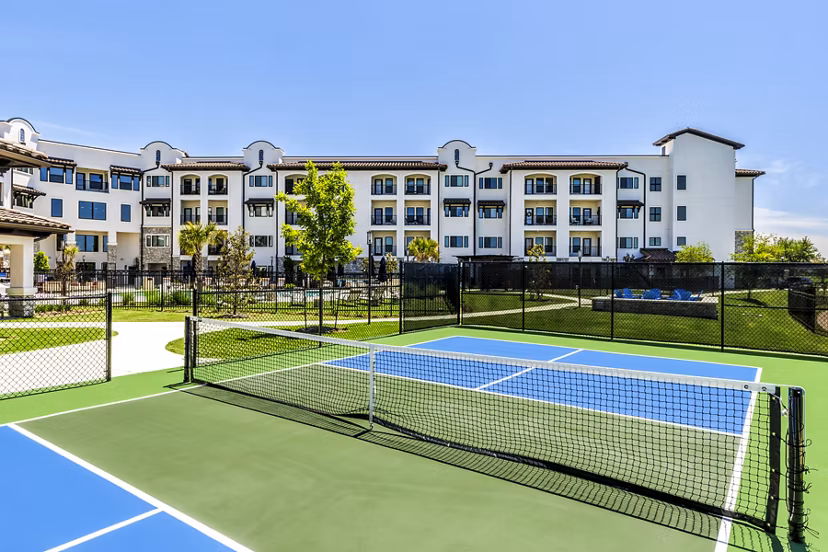 Outdoor tennis court at Arista Riverstone Apartments offering recreational facilities for residents