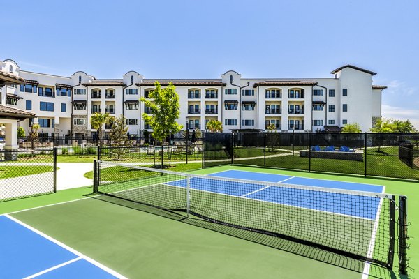 Outdoor tennis court at Arista Riverstone Apartments offering recreational facilities for residents