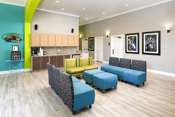 Lobby area with stylish seating and modern decor at The Lofts Apartments clubhouse, offering a luxurious living experience in a vibrant community
