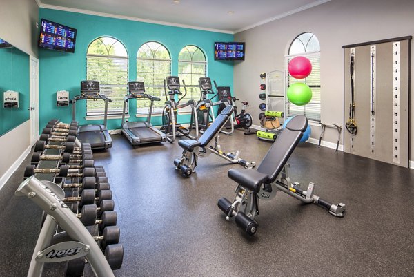 Fitness center equipped with modern exercise machines at The Lofts Apartments