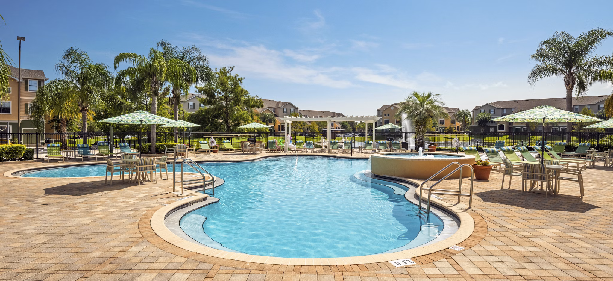 Relaxing poolside oasis with lounge chairs at The Lofts Apartments