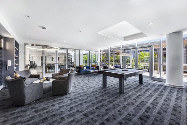 Clubhouse game room featuring pool table and lounge seating at Atlantic Station West Apartments, luxury living in Stamford, CT.