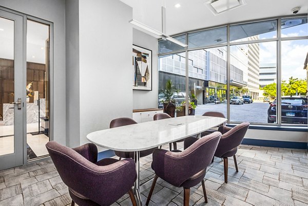 Clubhouse meeting facility with modern seating and AV equipment at Atlantic Station West Apartments