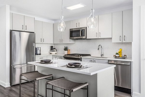 Kitchen featuring stainless steel appliances and modern cabinetry at Atlantic Station West Apartments, Greystar property
