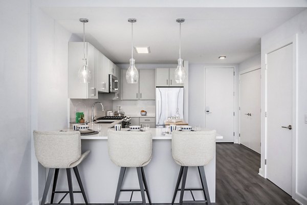 Atlantic Station West Apartments: Modern kitchen with stainless steel appliances and granite countertops