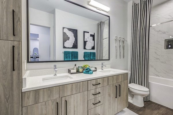 Candour House Apartments: Modern bathroom featuring sleek fixtures and elegant tiling