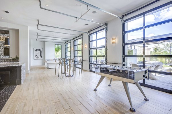 Clubhouse game room with modern decor and pool table at Candour House Apartments, a luxury destination for relaxation and entertainment