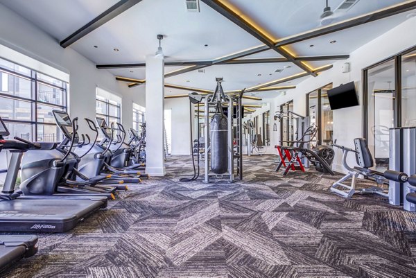 Fitness facility equipped with state-of-the-art machines at Candour House Apartments, an upscale feature for residents focused on health and wellness