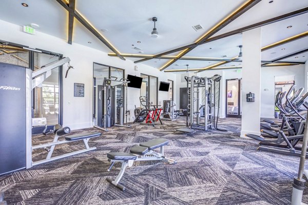 Modern fitness center with state-of-the-art equipment at Candour House Apartments