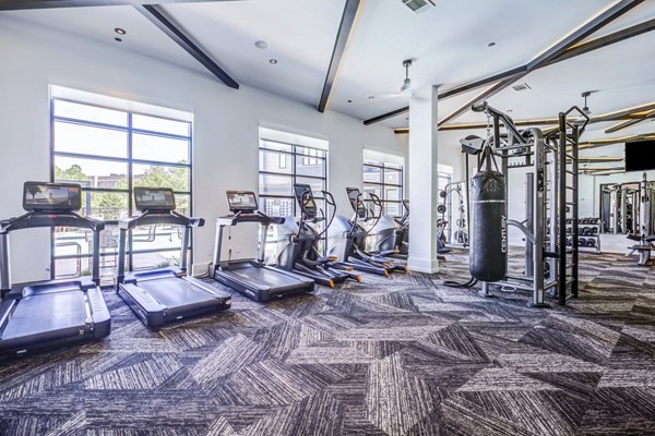 State-of-the-art fitness center featuring modern equipment at Candour House Apartments, offering luxury living in a Greystar community