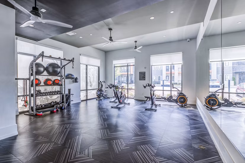 Fitness center featuring state-of-the-art equipment at Candour House Apartments, offering luxury living with wellness amenities