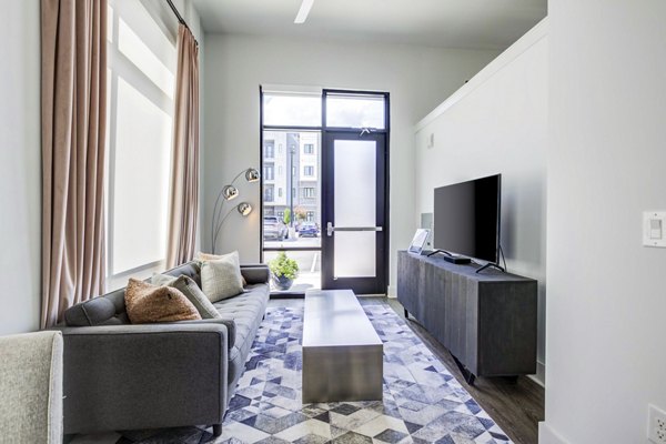 Spacious living room with modern decor at Candour House Apartments