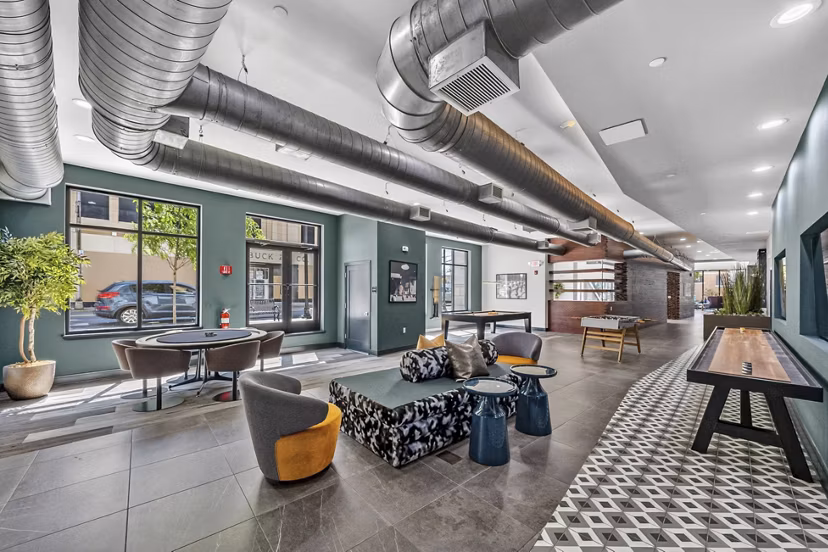 Clubhouse at The Walcott Hackensack: Modern social space with stylish seating and large windows in luxury apartments