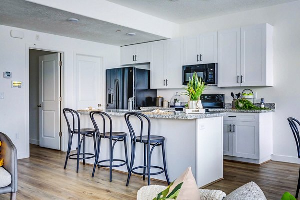 Kitchen featuring stainless steel appliances and granite countertops in Jules on 3rd Apartments