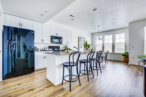 Modern kitchen with stainless steel appliances at Jules on 3rd Apartments