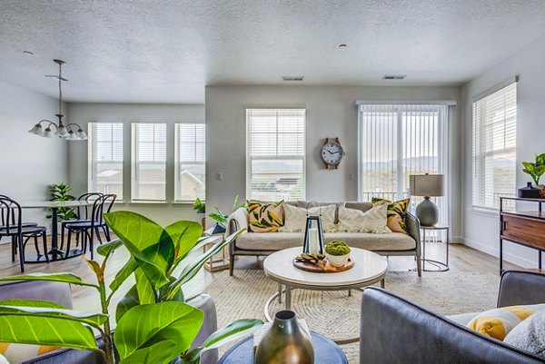 Open-concept kitchen and dining area with modern finishes in Jules on 3rd Apartments