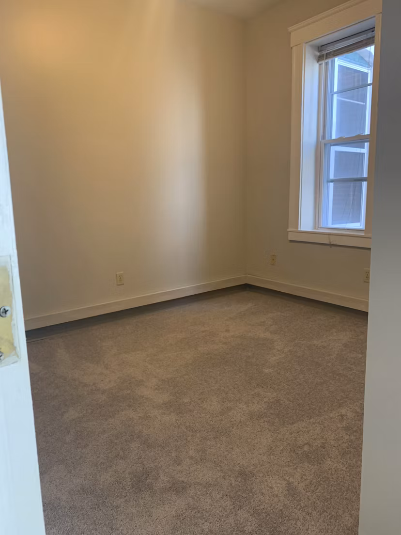Bedroom featuring modern decor and large windows at Colton Apartments