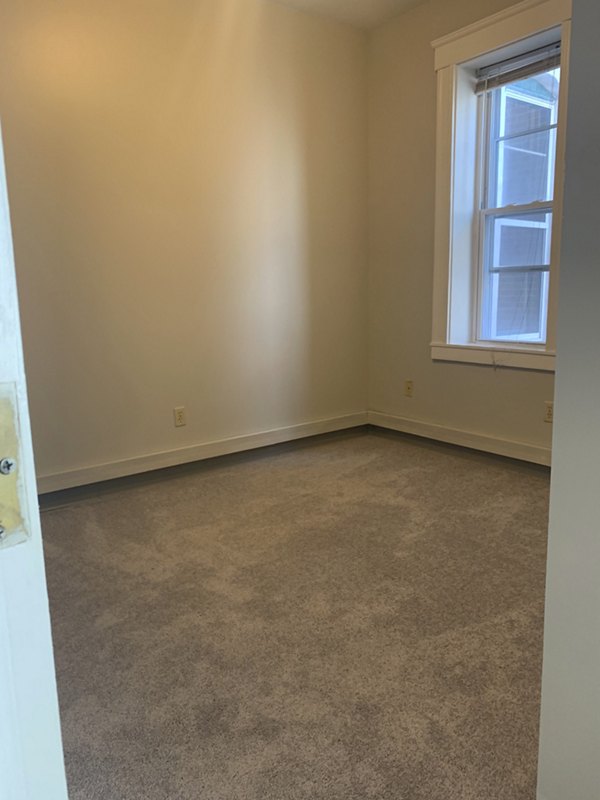Bedroom featuring modern decor and large windows at Colton Apartments