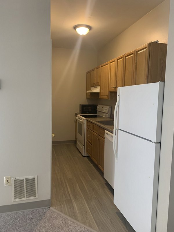 Modern kitchen with sleek countertops and stainless steel appliances in Colton Apartments, Greystar luxury apartments