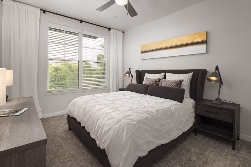 Modern bedroom featuring stylish decor and ample natural light at Tapestry at Brentwood Town Center Apartments