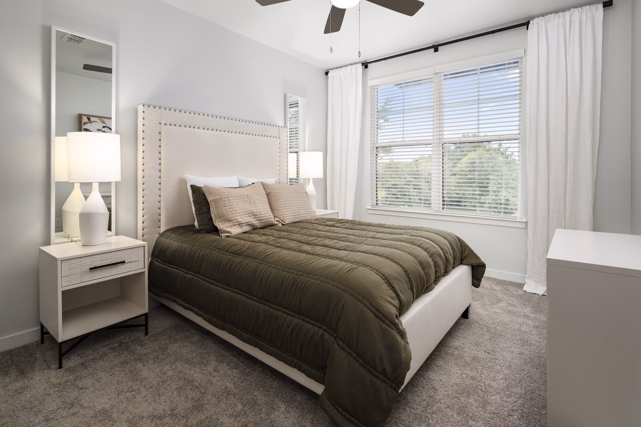 Modern bedroom featuring stylish decor and ample natural light at Tapestry at Brentwood Town Center Apartments