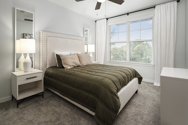 Modern bedroom featuring stylish decor and ample natural light at Tapestry at Brentwood Town Center Apartments