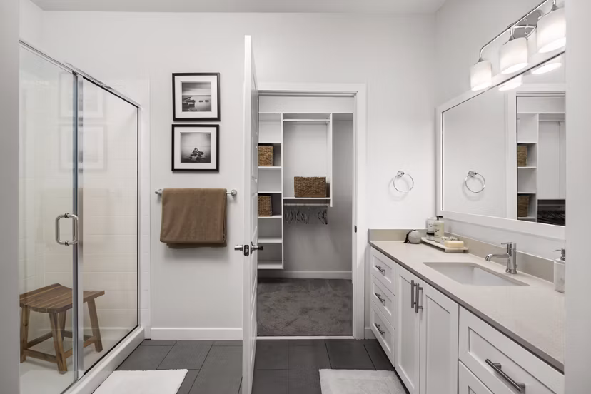 Guest bathroom with elegant fixtures and large vanity mirror in Tapestry at Brentwood Town Center Apartments, perfect for luxury living
