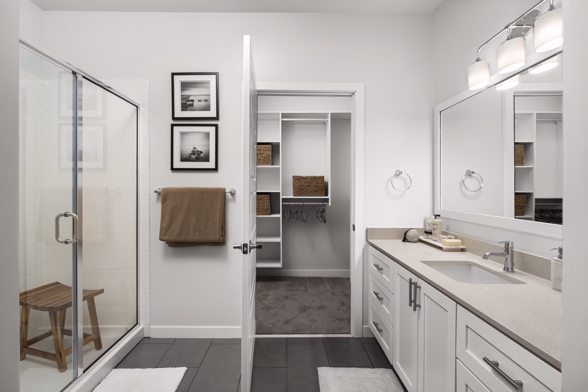 Guest bathroom with elegant fixtures and large vanity mirror in Tapestry at Brentwood Town Center Apartments, perfect for luxury living
