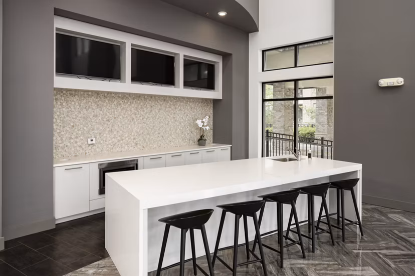 Modern clubhouse with cozy seating and fireplace at Tapestry at Brentwood Town Center Apartments