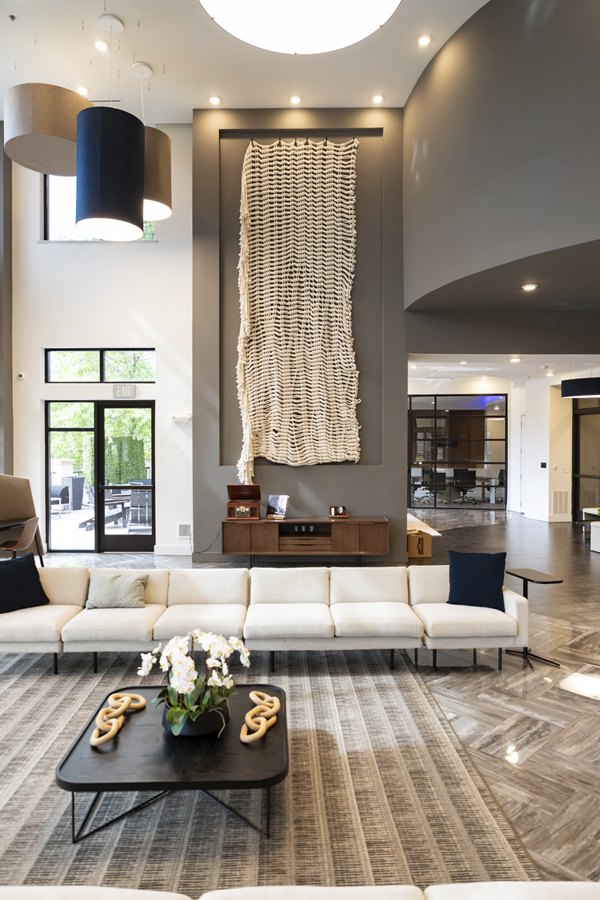 Modern clubhouse with cozy seating and fireplace at Tapestry at Brentwood Town Center Apartments